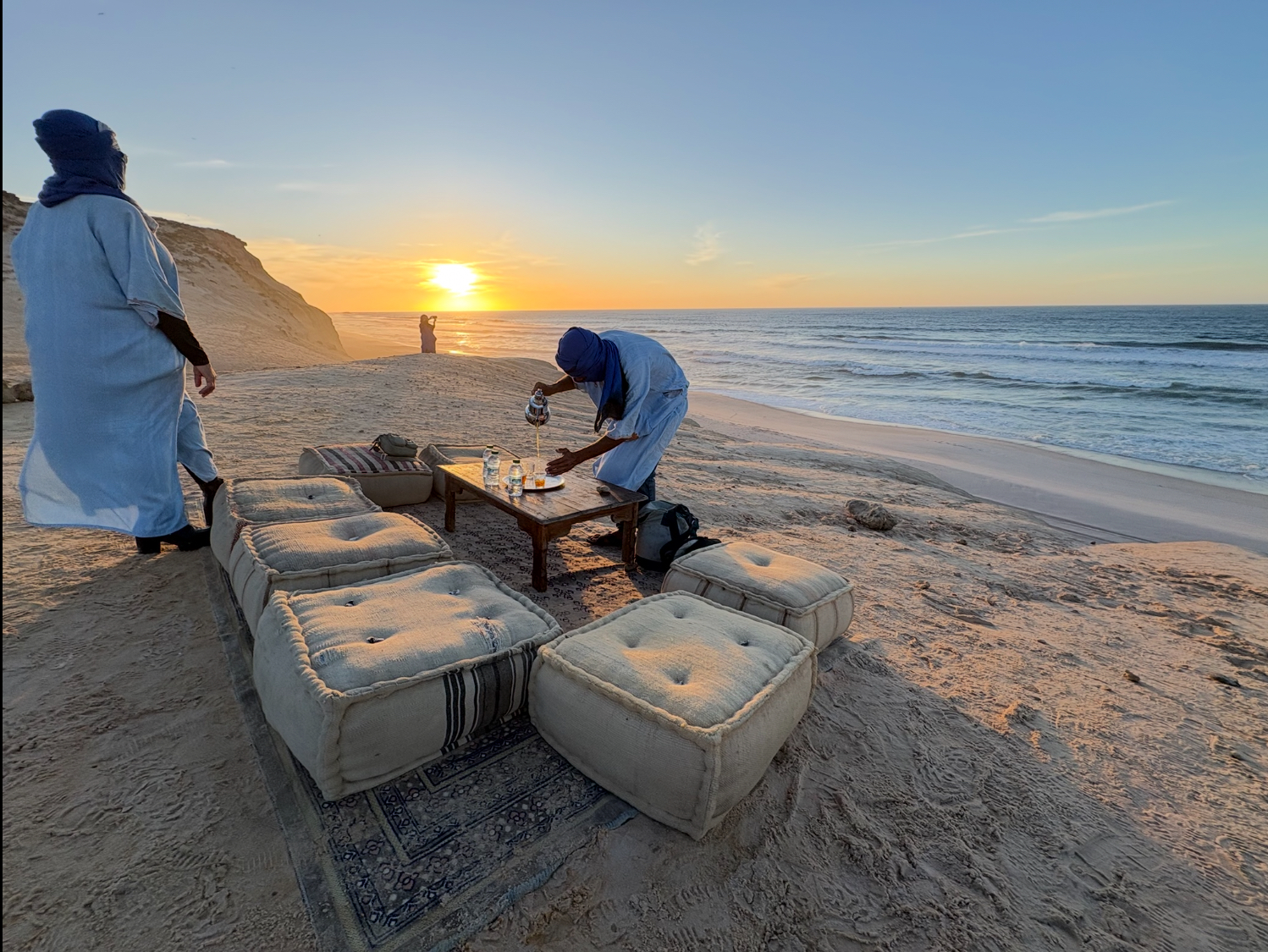 Traditional Sahrawi tea ceremony on the Atlantic shore at sunset